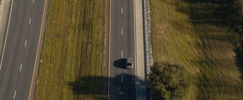 Movie still from “Paper Towns” (2015), directed by Jake Schreier – An aerial view of a truck driving down a road; Extreme Wide shot, High angle
