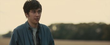 Movie still from “Paper Towns” (2015), directed by Jake Schreier – A young man in a blue jacket is looking at the camera; Close Up shot, Over the shoulder angle
