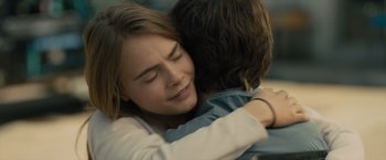 Movie still from “Paper Towns” (2015), directed by Jake Schreier – A woman hugging a man in a room; Close Up shot, Over the shoulder angle