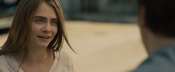 Movie still from “Paper Towns” (2015), directed by Jake Schreier – A person wearing glasses and smiling; Close Up shot, Over the shoulder angle