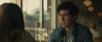 Movie still from “Paper Towns” (2015), directed by Jake Schreier – A young man wearing headphones sitting in front of a window; Close Up shot, Over the shoulder angle