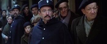 Movie still from “Papillon” (1973), directed by Franklin J. Schaffner – A group of men standing next to each other; Medium shot, Low angle