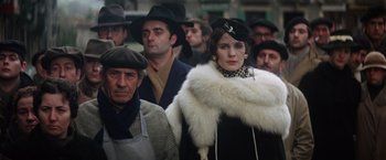 Movie still from “Papillon” (1973), directed by Franklin J. Schaffner – A group of people standing around each other wearing hats; Medium shot, Low angle