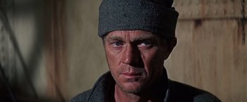 Movie still from “Papillon” (1973), directed by Franklin J. Schaffner – A person wearing a hat; Close Up shot, Low angle