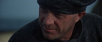 Movie still from “Papillon” (1973), directed by Franklin J. Schaffner – A person wearing a hat; Close Up shot, Over the shoulder angle