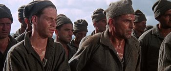 Movie still from “Papillon” (1973), directed by Franklin J. Schaffner – A group of men standing next to each other; Close Up shot, Low angle