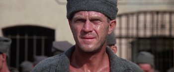 Movie still from “Papillon” (1973), directed by Franklin J. Schaffner – A person wearing a hat; Close Up shot, Low angle