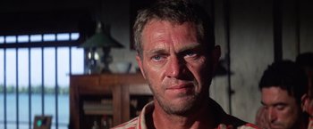 Movie still from “Papillon” (1973), directed by Franklin J. Schaffner – A person wearing a red shirt; Close Up shot, Low angle