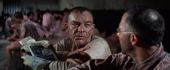 Movie still from “Papillon” (1973), directed by Franklin J. Schaffner – A person sitting on a couch; Close Up shot, Over the shoulder angle