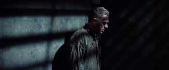 Movie still from “Papillon” (1973), directed by Franklin J. Schaffner – A man in a dirty shirt is standing in the dark; Close Up shot, Low angle