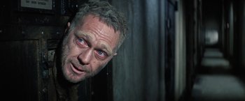 Movie still from “Papillon” (1973), directed by Franklin J. Schaffner – A person with blue eyes looking at the camera; Close Up shot, High angle