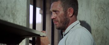 Movie still from “Papillon” (1973), directed by Franklin J. Schaffner – A person writing on a piece of paper; Close Up shot, Low angle