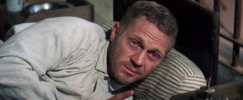 Movie still from “Papillon” (1973), directed by Franklin J. Schaffner – A person laying on the ground; Close Up shot, High angle