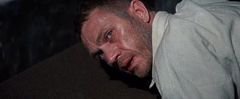 Movie still from “Papillon” (1973), directed by Franklin J. Schaffner – A person looking at the camera; Close Up shot, Low angle