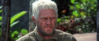 Movie still from “Papillon” (1973), directed by Franklin J. Schaffner – An older man with white hair and a beard; Close Up shot, Low angle