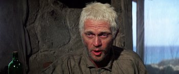 Movie still from “Papillon” (1973), directed by Franklin J. Schaffner – A person with white hair; Close Up shot, Over the shoulder angle