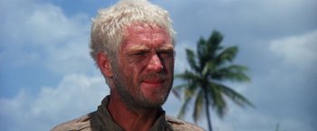 Movie still from “Papillon” (1973), directed by Franklin J. Schaffner – A person with white hair; Close Up shot, Low angle