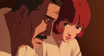 An older man and a younger woman looking at each other