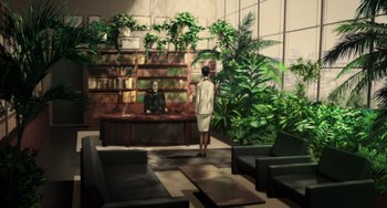 Movie still from “Paprika” (2006), directed by Satoshi Kon – A woman standing in front of a desk in a room filled with plants; Wide shot, High angle