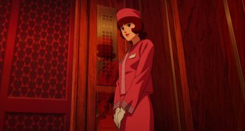 Movie still from “Paprika” (2006), directed by Satoshi Kon – An animated picture of a woman in a red outfit; Medium shot, Low angle