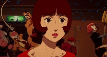 Movie still from “Paprika” (2006), directed by Satoshi Kon – An animated picture of a woman with short brown hair; Close Up shot, Low angle