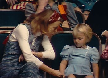 Movie still from “Parade” (1974), directed by Jacques Tati – An older woman and a young girl sitting in a theater; Medium shot, High angle