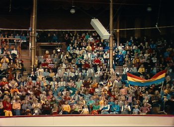 Movie still from “Parade” (1974), directed by Jacques Tati – A crowd of people sitting in a stadium; Extreme Wide shot, High angle