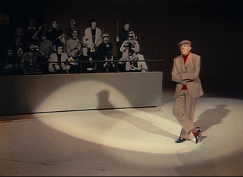 Movie still from “Parade” (1974), directed by Jacques Tati – A wax statue of a man in a suit and hat; Wide shot, Low angle