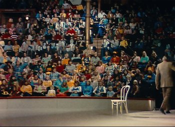 Movie still from “Parade” (1974), directed by Jacques Tati – A crowd of people sitting in front of an audience; Extreme Wide shot, High angle