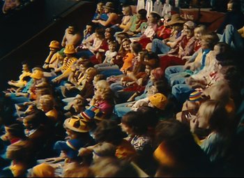 Movie still from “Parade” (1974), directed by Jacques Tati – A crowd of people sitting in a stadium; Extreme Wide shot, High angle