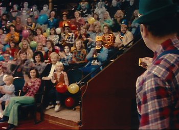 Movie still from “Parade” (1974), directed by Jacques Tati – A crowd of people sitting in front of an audience; Wide shot, High angle