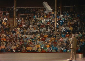 Movie still from “Parade” (1974), directed by Jacques Tati – A crowd of people sitting in front of an audience; Extreme Wide shot, High angle