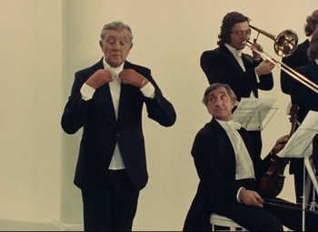 Movie still from “Parade” (1974), directed by Jacques Tati – A group of men in suits and bow ties; Medium shot, Low angle