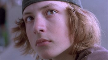 Movie still from “Paranoid Park” (2007), directed by Gus Van Sant – A person's eyes and hair; Close Up shot, Low angle