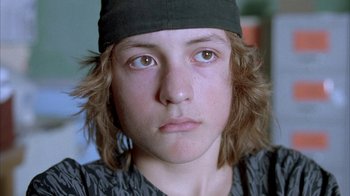 Movie still from “Paranoid Park” (2007), directed by Gus Van Sant – A person wearing a hat; Close Up shot, Low angle