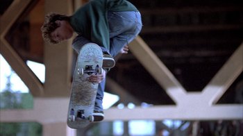 Movie still from “Paranoid Park” (2007), directed by Gus Van Sant – A skateboarder in the air doing a trick on a skateboard; Medium shot, Low angle