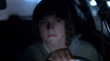 Movie still from “Paranoid Park” (2007), directed by Gus Van Sant – A young man sitting in a car at night; Close Up shot, High angle