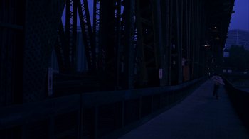 Movie still from “Paranoid Park” (2007), directed by Gus Van Sant – A night time view of a bridge with a dark sky in the background; Extreme Wide shot, High angle