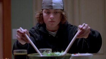 Movie still from “Paranoid Park” (2007), directed by Gus Van Sant – A person sitting at a table with a bowl of food; Close Up shot, Overhead angle