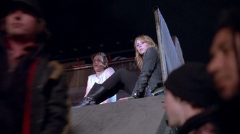Movie still from “Paranoid Park” (2007), directed by Gus Van Sant – Two young people sitting on a wall at night; Medium shot, Low angle