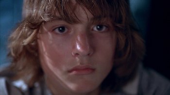 Movie still from “Paranoid Park” (2007), directed by Gus Van Sant – A young person's face with long brown hair; Close Up shot, Low angle