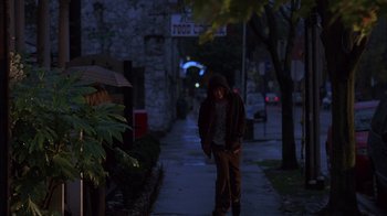 Movie still from “Paranoid Park” (2007), directed by Gus Van Sant – A man walking down a sidewalk at night; Wide shot, Low angle