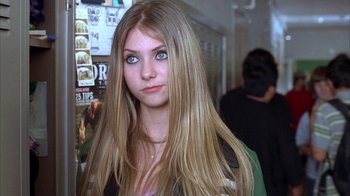 Movie still from “Paranoid Park” (2007), directed by Gus Van Sant – A girl with long blonde hair and blue eyes looking at the camera; Close Up shot, Over the shoulder angle