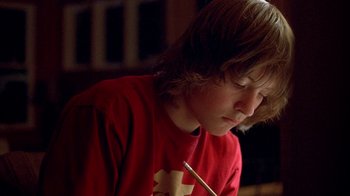 Movie still from “Paranoid Park” (2007), directed by Gus Van Sant – A young boy is holding a pencil in his hand; Close Up shot, Low angle