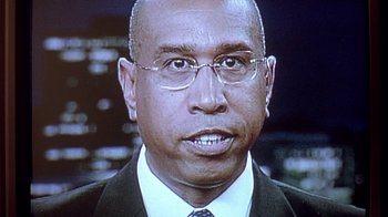 Movie still from “Paranoid Park” (2007), directed by Gus Van Sant – A man in a suit and tie with glasses; Extreme Close Up shot, Low angle