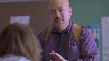 Movie still from “Paranoid Park” (2007), directed by Gus Van Sant – A man in a purple shirt and a green neck tie; Medium shot, Over the shoulder angle