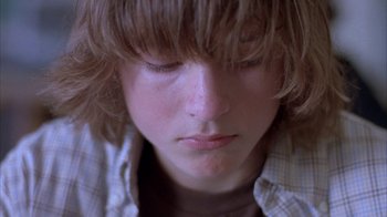 Movie still from “Paranoid Park” (2007), directed by Gus Van Sant – A person with long brown hair; Close Up shot, Low angle