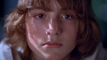 Movie still from “Paranoid Park” (2007), directed by Gus Van Sant – A young person's face with a lot of light shining on them; Extreme Close Up shot, Low angle