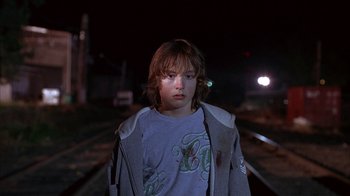 Movie still from “Paranoid Park” (2007), directed by Gus Van Sant – A young boy standing on train tracks at night; Close Up shot, Low angle