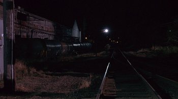 Movie still from “Paranoid Park” (2007), directed by Gus Van Sant – A train is on the tracks at night time; Extreme Wide shot, High angle